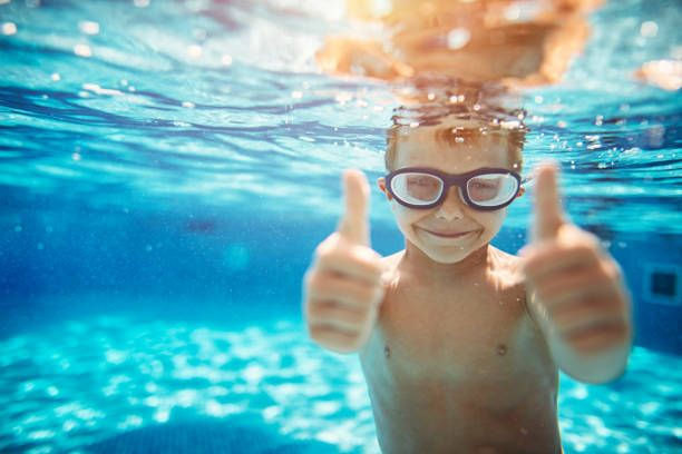 kid in heated pool at a resort